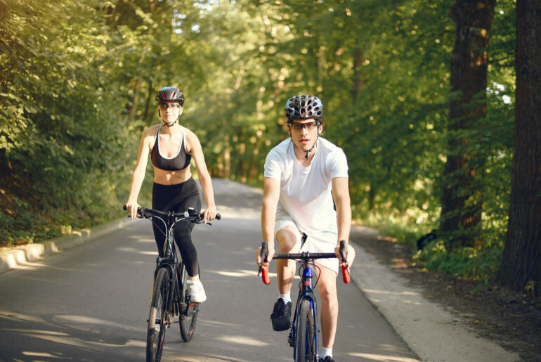 A Couple cycling on road