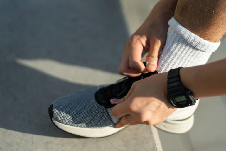 person trying on running shoe
